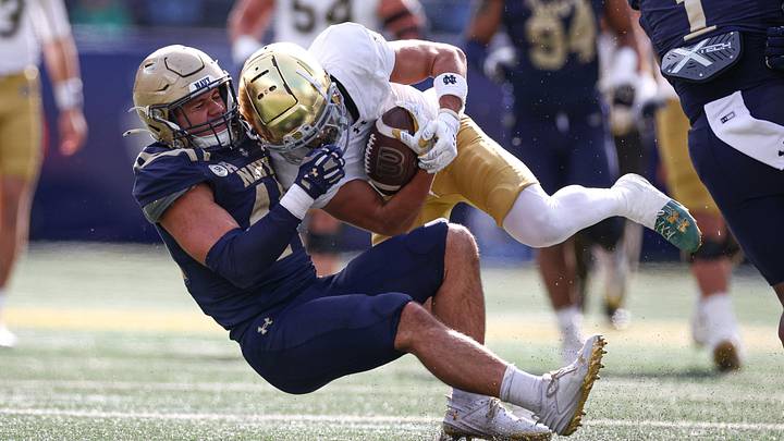 Oct 26, 2024; East Rutherford, New Jersey, USA; Notre Dame Fighting Irish wide receiver Jordan Faison (6) is tackled by Navy Midshipmen linebacker Colin Ramos (44) during the first half at MetLife Stadium. Oct 26, 2024; East Rutherford, New Jersey, USA; Notre Dame Fighting Irish wide receiver Jordan Faison (6) is tackled by Navy Midshipmen linebacker Colin Ramos (44) during the first half at MetLife Stadium.