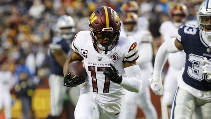Jan 8, 2023; Landover, Maryland, USA; Washington Commanders wide receiver Terry McLaurin (17) runs with the ball for a touchdown as Dallas Cowboys linebacker Damone Clark (33) chases during the first quarter at FedExField. Mandatory Credit: Geoff Burke-Imagn Images