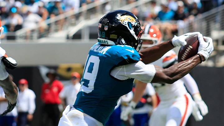 Jacksonville Jaguars wide receiver Josh Cameron (19) hauls in a touchdown reception against Cleveland Browns cornerback Denzel Ward (21) during the first quarter of an NFL football matchup at EverBank Stadium on Sunday, Sept. 13, 2026, in Jacksonville, Fla. The Jaguars defeated the Browns 34-10.