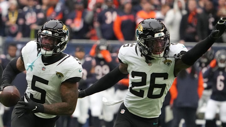 Oct 13, 2024; London, United Kingdom; Jacksonville Jaguars safety Andre Cisco (5) and safety Antonio Johnson (26) celebrate after an interception against the Chicago Bears in the first half during an NFL International Series game at Tottenham Hotspur Stadium. Mandatory Credit: Kirby Lee-Imagn Images