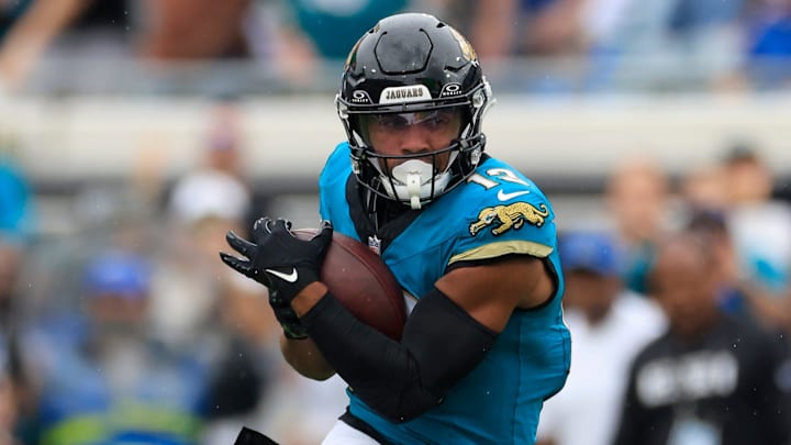 Jacksonville Jaguars wide receiver Christian Kirk (13) rushes for yards after a catch against Indianapolis Colts safety Julian Blackmon (32) during the fourth quarter of an NFL football matchup Sunday, Oct. 6, 2024 at EverBank Stadium in Jacksonville, Fla. The Jaguars edged the Colts on a field goal 37-34. [Corey Perrine/Florida Times-Union]