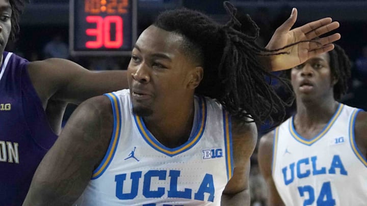 Dec 3, 2024; Los Angeles, California, USA; UCLA Bruins guard Sebastian Mack (12) dribbles the ball against Washington Huskies guard Zoom Diallo (9) in the second half at Pauley Pavilion presented by Wescom. Mandatory Credit: Kirby Lee-Imagn Images