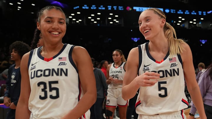 Dec 7, 2024; Brooklyn, New York, USA; Connecticut Huskies guard Azzi Fudd (35) and Connecticut Huskies guard Paige Bueckers (5) celebrate after the game against the Louisville Cardinals at Barclays Center. Mandatory Credit: Lucas Boland-Imagn Images