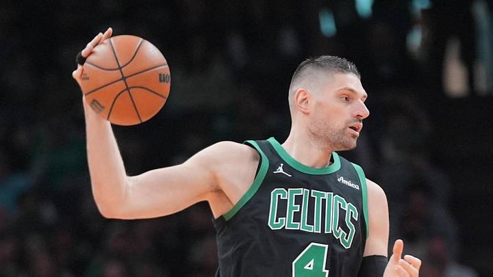 Boston Celtics center Nikola Vucevic receives a pass against Toronto Raptors forward Collin Murray-Boyles. Boston Celtics center Nikola Vucevic receives a pass against Toronto Raptors forward Collin Murray-Boyles.