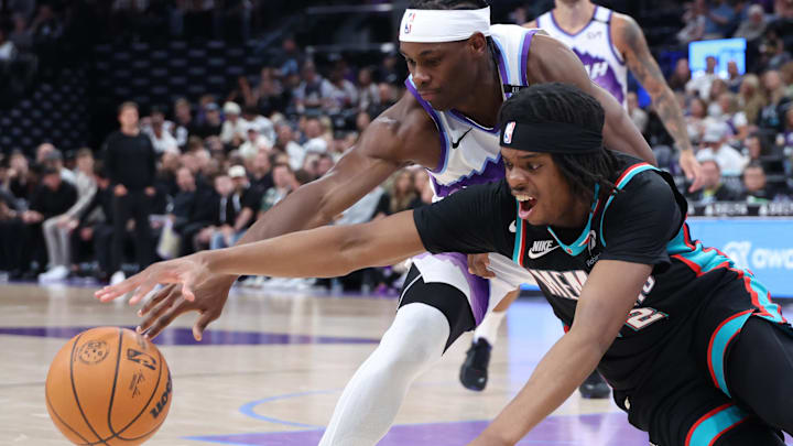 Apr 10, 2026; Salt Lake City, Utah, USA; Utah Jazz guard Bez Mbeng (21) and Memphis Grizzlies guard Adama Bal (72) reach for a loose ball during the second half at Delta Center. Mandatory Credit: Rob Gray-Imagn Images