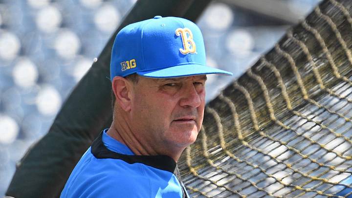 Jun 14, 2025; Omaha, Neb, USA; UCLA Bruins head coach John Savage watches the team warm up before the game against the Murray State Races at Charles Schwab Field. Mandatory Credit: Steven Branscombe-Imagn Images Jun 14, 2025; Omaha, Neb, USA; UCLA Bruins head coach John Savage watches the team warm up before the game against the Murray State Races at Charles Schwab Field. Mandatory Credit: Steven Branscombe-Imagn Images
