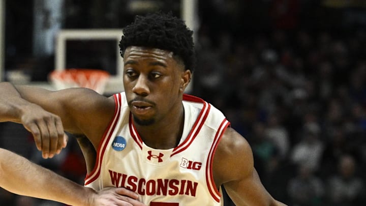 Mar 19, 2026; Portland, OR, USA; Wisconsin Badgers guard John Blackwell (25) drives against High Point Panthers guard Conrad Martinez (9) during the second half of a first round game of the men's 2026 NCAA Tournament at Moda Center. Mandatory Credit: Troy Wayrynen-Imagn Images