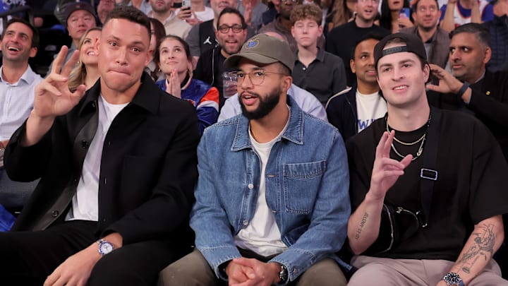 Oct 22, 2025; New York, New York, USA; New York Yankees players (left to right) Aaron Judge and Devin Williams and Cam Schlittler react to being shown on the video board during the second quarter of an opening night game between the New York Knicks and Cleveland Cavaliers at Madison Square Garden. Mandatory Credit: Brad Penner-Imagn Images