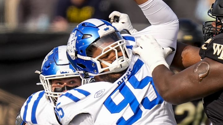 Nov 30, 2024; Winston-Salem, North Carolina, USA;  Duke Blue Devils defensive tackle Preston Watson (95) tries to elude Wake Forest Demon Deacons offensive lineman Erik Russell (72) during the first half at Allegacy Federal Credit Union Stadium. Mandatory Credit: Jim Dedmon-Imagn Images