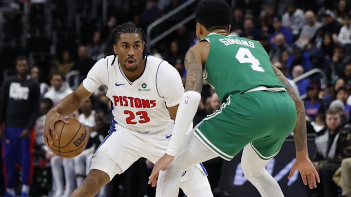 Jan 19, 2026; Detroit, Michigan, USA;  Detroit Pistons guard Jaden Ivey (23) dribbles against Boston Celtics guard Anfernee Simons (4) in the second half at Little Caesars Arena. Mandatory Credit: Rick Osentoski-Imagn Images