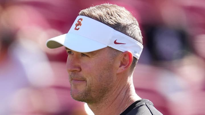 Aug 30, 2025; Los Angeles, California, USA; Missouri State Bears head coach Ryan Beard (left) and Southern California Trojans head coach Lincoln Riley talk during the game at United Airlines Field at Los Angeles Memorial Coliseum. Mandatory Credit: Kirby Lee-Imagn Images