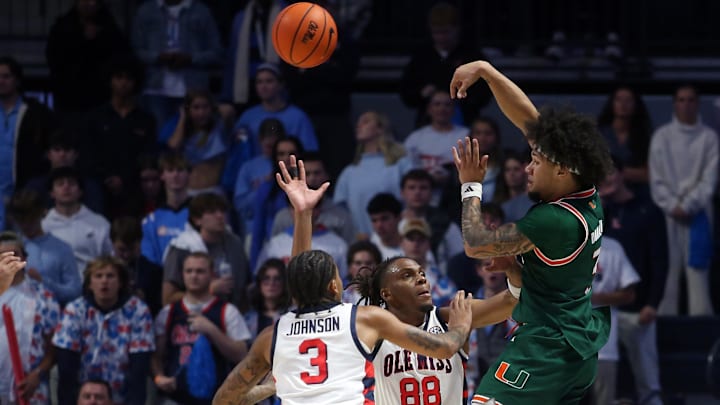 Dec 2, 2025; Oxford, Mississippi, USA; Miami Hurricanes guard Tre Donaldson (3) passes the ball as Mississippi Rebels guard Koren Johnson (3) and forward Augusto Cassiá (88) defend during the second half at The Sandy and John Black Pavilion at Ole Miss. Mandatory Credit: Petre Thomas-Imagn Images