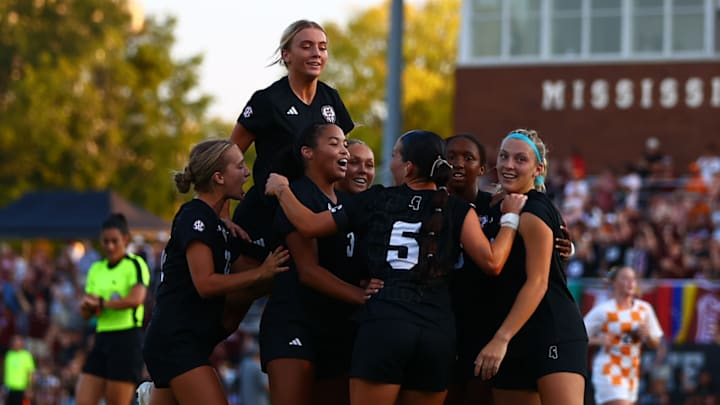 Mississippi State soccer players celebrate with Ally Perry, center, after one of her two goals to beat No. 1 Tennessee, 3-2.