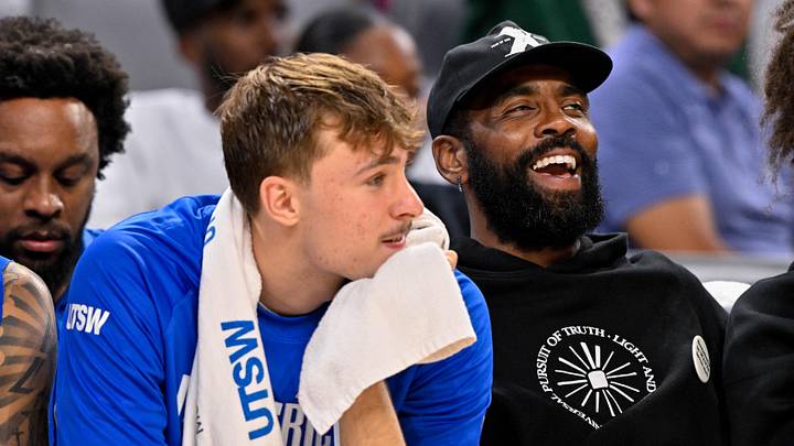 Oct 6, 2025; Fort Worth, Texas, USA; Dallas Mavericks forward Cooper Flagg (left) and guard Kyrie Irving (right) look on during the game between the Dallas Mavericks and the Oklahoma City Thunder at Dickie's Arena. Mandatory Credit: Jerome Miron-Imagn Images