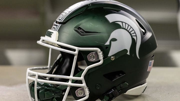 Nov 24, 2023; Detroit, Michigan, USA; A Michigan State Spartans helmet sits on a bench during the second half game against the Penn State Nittany Lions at Ford Field. Mandatory Credit: David Reginek-Imagn Images Nov 24, 2023; Detroit, Michigan, USA; A Michigan State Spartans helmet sits on a bench during the second half game against the Penn State Nittany Lions at Ford Field. Mandatory Credit: David Reginek-Imagn Images