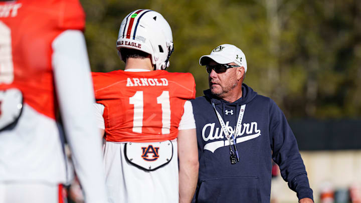 Auburn Tigers head coach Hugh Freeze works with new quarterback Jackson Arnold at spring practice.