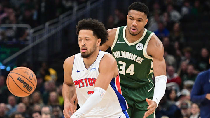 Dec 16, 2023; Milwaukee, Wisconsin, USA;  Detroit Pistons guard Cade Cunningham (2) is guarded by Milwaukee Bucks forward Giannis Antetokounmpo (34) in the first quarter at Fiserv Forum. Mandatory Credit: Benny Sieu-Imagn Images