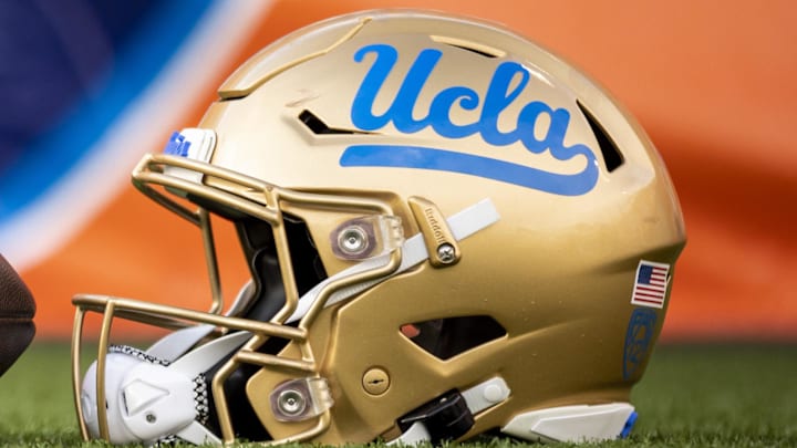 Dec 30, 2022; El Paso, Texas, USA; Helmets of the Pittsburgh Panthers and UCLA Bruins are posed in front of the logo before the 2022 Sun Bowl at Sun Bowl. Mandatory Credit: Ivan Pierre Aguirre-Imagn Images