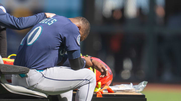 Seattle Mariners right fielder Victor Robles (10) is injured during the play against the San Francisco Giants during the ninth inning attended medical personal at Oracle Park on April 6. 