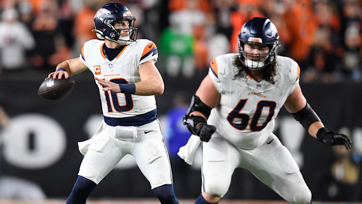CINCINNATI, OH - DECEMBER 28: Denver Broncos Quarterback Bo Nix (10) passes as Denver Broncos Center Luke Wattenberg (60) blocks during the NFL, American Football Herren, USA football game between the Denver Broncos and the Cincinnati Bengals on December 28, 2024, at Paycor Stadium in Cincinnati, Ohio. CINCINNATI, OH - DECEMBER 28: Denver Broncos Quarterback Bo Nix (10) passes as Denver Broncos Center Luke Wattenberg (60) blocks during the NFL, American Football Herren, USA football game between the Denver Broncos and the Cincinnati Bengals on December 28, 2024, at Paycor Stadium in Cincinnati, Ohio.