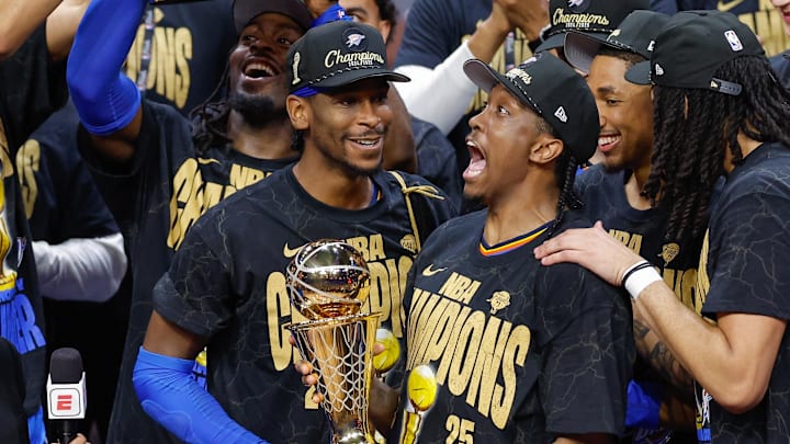 Jun 22, 2025; Oklahoma City, Oklahoma, USA; Oklahoma City Thunder forward Jalen Williams (8) holds up the Bill Russell NBA Finals MVP trophy after winner Oklahoma City Thunder guard Shai Gilgeous-Alexander hands it to him at the end of game seven of the 2025 NBA Finals against the Indiana Pacers at Paycom Center. Mandatory Credit: Alonzo Adams-Imagn Images