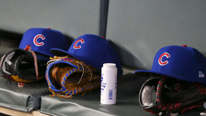 Apr 3, 2019; Atlanta, GA, USA; Detailed view of Chicago Cubs hats and gloves in the dugout against the Atlanta Braves in the fifth inning at SunTrust Park. Mandatory Credit: Brett Davis-Imagn Images
