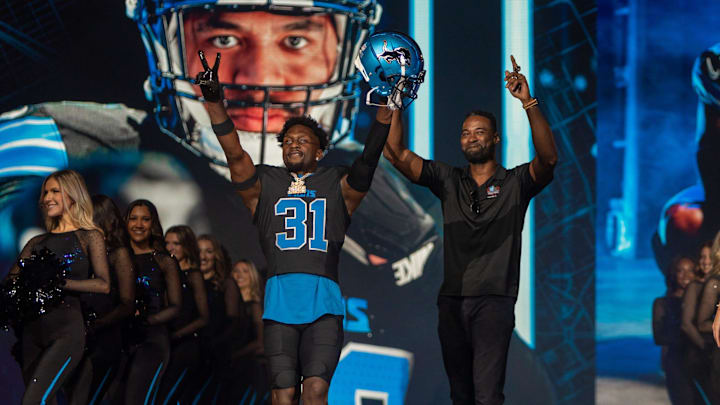 Kerby Joseph (31) and Calvin Johnson stand on stage during the Detroit Lions' new uniform reveal event