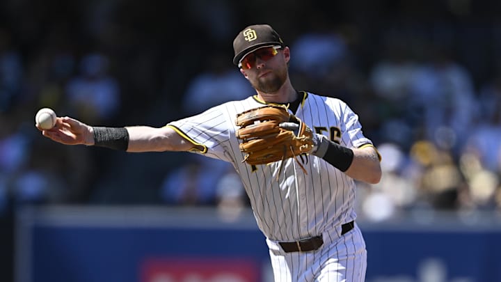 Sep 24, 2025; San Diego, California, USA; San Diego Padres second baseman Jake Cronenworth (9) throws to first base but canít turn the double play as Milwaukee Brewers second baseman Brice Turang (2) slides into second base during the third inning at Petco Park. Mandatory Credit: Denis Poroy-Imagn Images