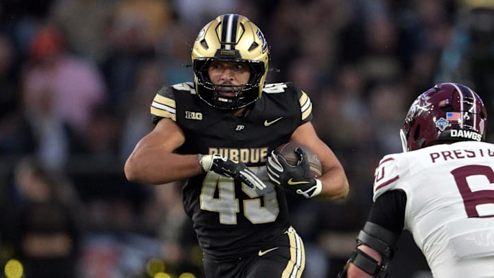 Purdue Boilermakers running back Devin Mockobee runs past Southern Illinois Salukis linebacker Chris Presto 