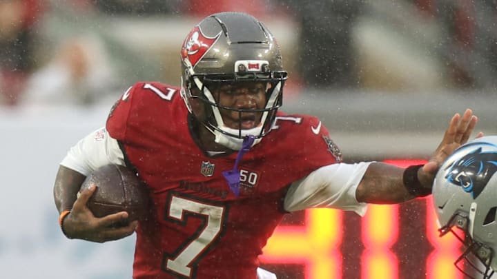 Jan 3, 2026; Tampa, Florida, USA; Tampa Bay Buccaneers running back Bucky Irving (7) runs against Carolina Panthers cornerback Chau Smith-Wade (26) in the first half at Raymond James Stadium. Mandatory Credit: Nathan Ray Seebeck-Imagn Images
