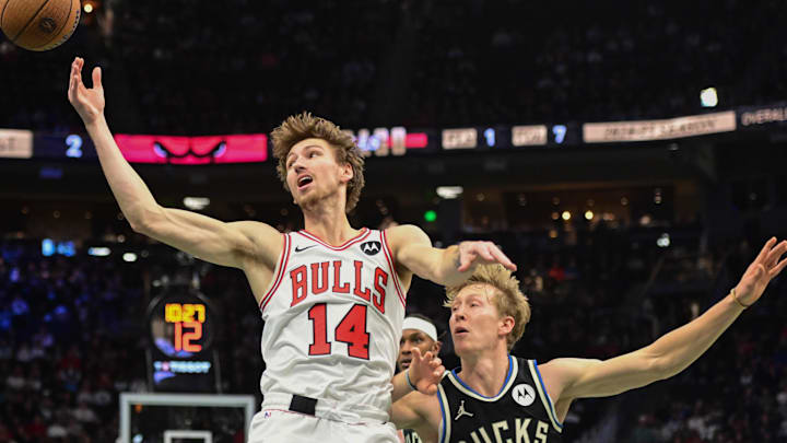 Nov 7, 2025; Milwaukee, Wisconsin, USA; Chicago Bulls forward Matas Buzelis (14) reaches for the ball against Milwaukee Bucks guard AJ Green (20) in the first quarter at Fiserv Forum. Mandatory Credit: Benny Sieu-Imagn Images