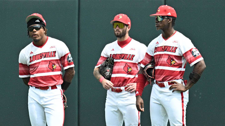 Jun 18, 2025; Omaha, Neb, USA; Louisville Cardinals left fielder Zion Rose (32), center fielder Lucas Moore (53), and right fielder Eddie King Jr. (42) wait out a pitching change sixth inning at Charles Schwab Field. Mandatory Credit: Steven Branscombe-Imagn Images Jun 18, 2025; Omaha, Neb, USA; Louisville Cardinals left fielder Zion Rose (32), center fielder Lucas Moore (53), and right fielder Eddie King Jr. (42) wait out a pitching change sixth inning at Charles Schwab Field. Mandatory Credit: Steven Branscombe-Imagn Images