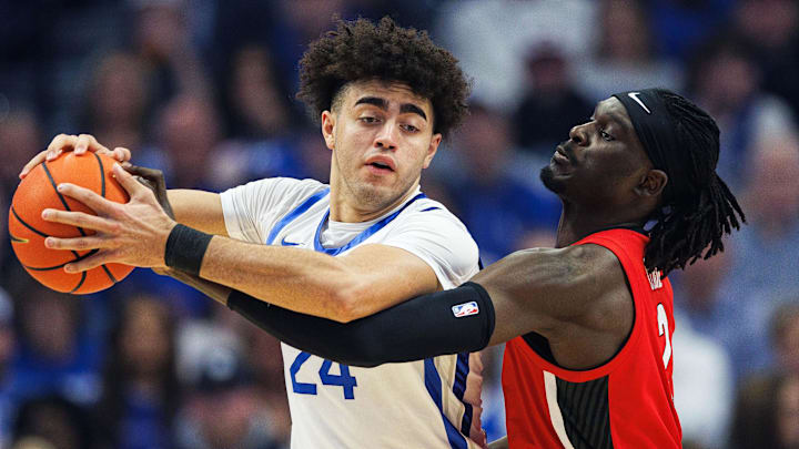 Feb 17, 2026; Lexington, Kentucky, USA; Georgia Bulldogs center Somto Cyril (2) attempts to steal the ball from Kentucky Wildcats center Malachi Moreno (24) during the first half at Rupp Arena at Central Bank Center. Mandatory Credit: Jordan Prather-Imagn Images