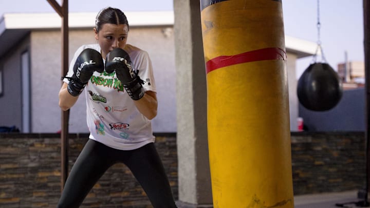 Ivy Enriquez, El Paso teen boxer, hits a punching bag while training on Friday, Feb. 7, 2025, at her home gym in El Paso, Texas. Ivy Enriquez, El Paso teen boxer, hits a punching bag while training on Friday, Feb. 7, 2025, at her home gym in El Paso, Texas.
