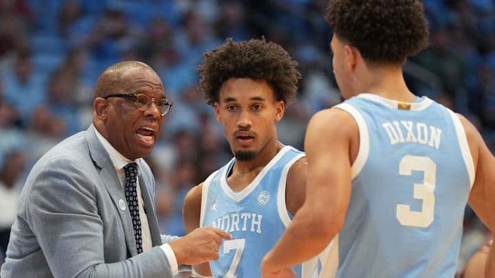 Dec 30, 2025; Chapel Hill, North Carolina, USA; North Carolina Tar Heels head coach Hubert Davis with guard Seth Trimble (7) and guard Derek Dixon (3) in the second half at Dean E. Smith Center. Mandatory Credit: Bob Donnan-Imagn Images Dec 30, 2025; Chapel Hill, North Carolina, USA; North Carolina Tar Heels head coach Hubert Davis with guard Seth Trimble (7) and guard Derek Dixon (3) in the second half at Dean E. Smith Center. Mandatory Credit: Bob Donnan-Imagn Images
