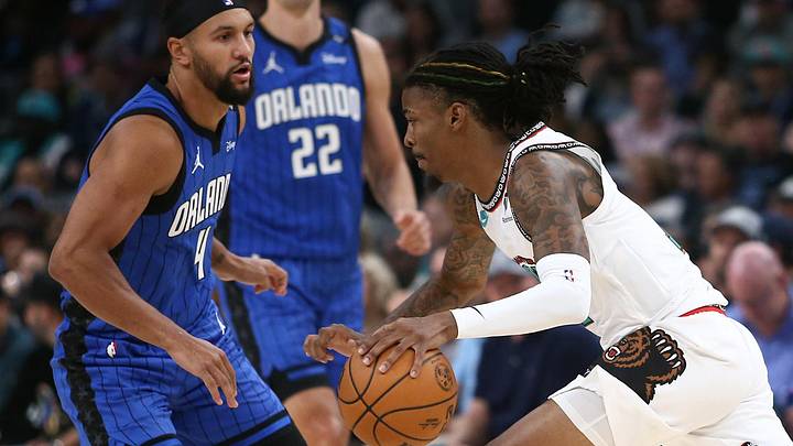 Oct 26, 2024; Memphis, Tennessee, USA; Memphis Grizzlies guard Ja Morant (12) drives to the basket as Orlando Magic guard Jalen Suggs (4) defends during the second half at FedExForum. Mandatory Credit: Petre Thomas-Imagn Images