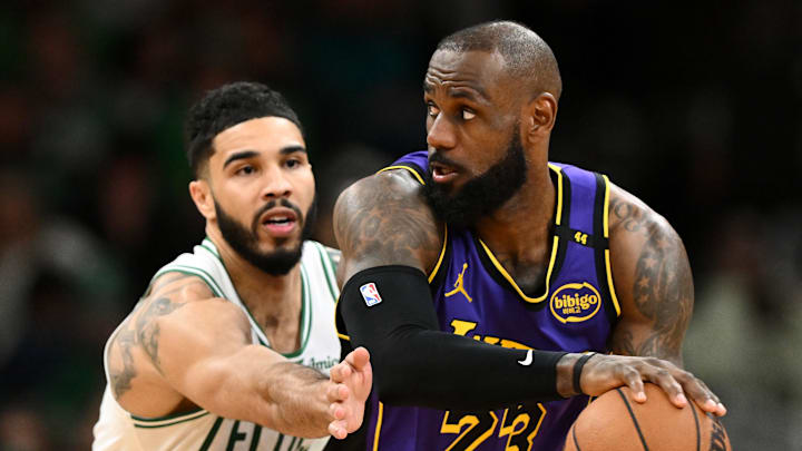 Boston Celtics forward Jayson Tatum guards Los Angeles Lakers forward LeBron James during a game.