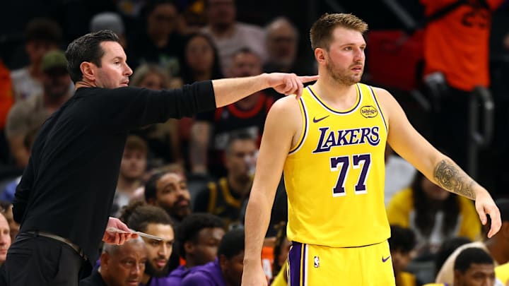 Oct 14, 2025; Phoenix, Arizona, USA; Los Angeles Lakers guard Luka Doncic (77) with head coach JJ Redick against the Phoenix Suns during an NBA preseason game at Mortgage Matchup Center. Mandatory Credit: Mark J. Rebilas-Imagn Images
Oct 14, 2025; Phoenix, Arizona, USA; Los Angeles Lakers guard Luka Doncic (77) with head coach JJ Redick against the Phoenix Suns during an NBA preseason game at Mortgage Matchup Center. Mandatory Credit: Mark J. Rebilas-Imagn Images