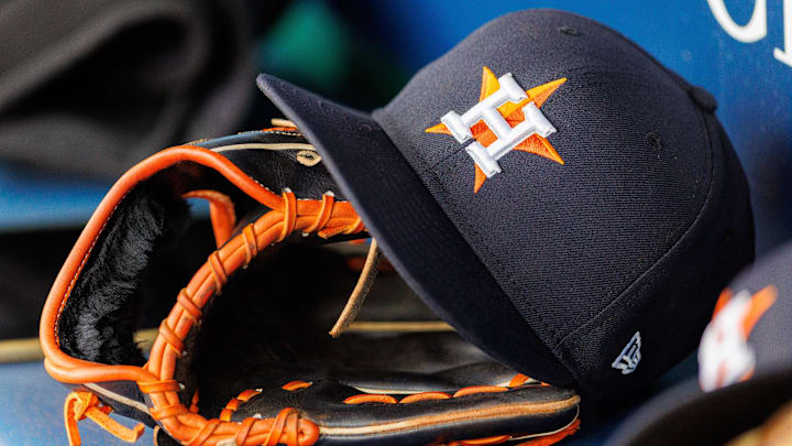 Apr 27, 2025; Kansas City, Missouri, USA; Houston Astros hat and glove in the dugout during the second inning against the Kansas City Royals at Kauffman Stadium. 