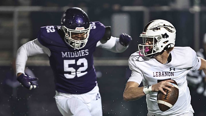 Lebanon QB Luke Faler (7) tries to evade Middletown's Jaiden Davis (52) during Middletown's 31-0 OHSAA Division I regional quarterfinal playoff win over Lebanon, Friday, Nov. 7, 2025.