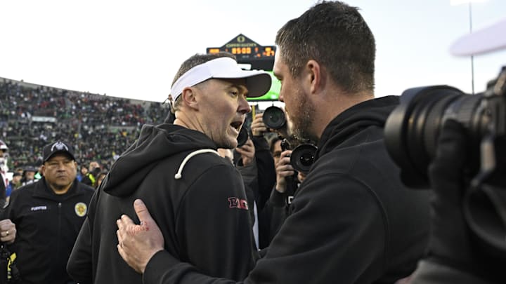 Nov 22, 2025; Eugene, Oregon, USA; Southern California Trojans head coach Lincoln Riley and Oregon Ducks head coach Dan Lanning greet each other after the game at Autzen Stadium.