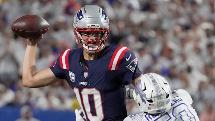 New England Patriots quarterback Drake Maye feels the pressure from Buffalo Bills defensive end Greg Rousseau. New England Patriots quarterback Drake Maye feels the pressure from Buffalo Bills defensive end Greg Rousseau.