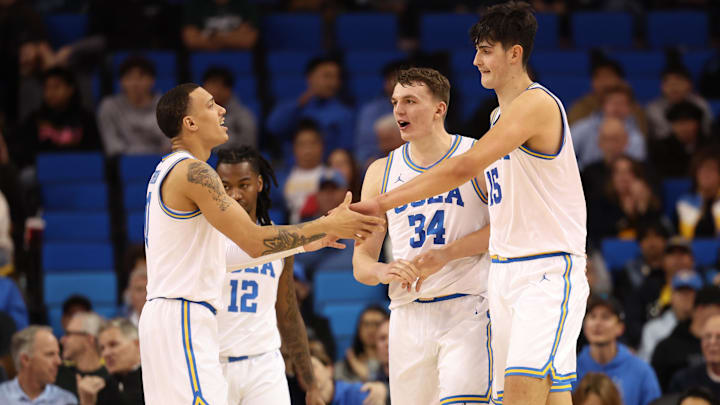 Jan 21, 2025; Los Angeles, California, USA;  UCLA Bruins center Aday Mara (15) is greeted by guard Kobe Johnson (0) during the second half against the Wisconsin Badgers at Pauley Pavilion presented by Wescom. Mandatory Credit: Kiyoshi Mio-Imagn Images