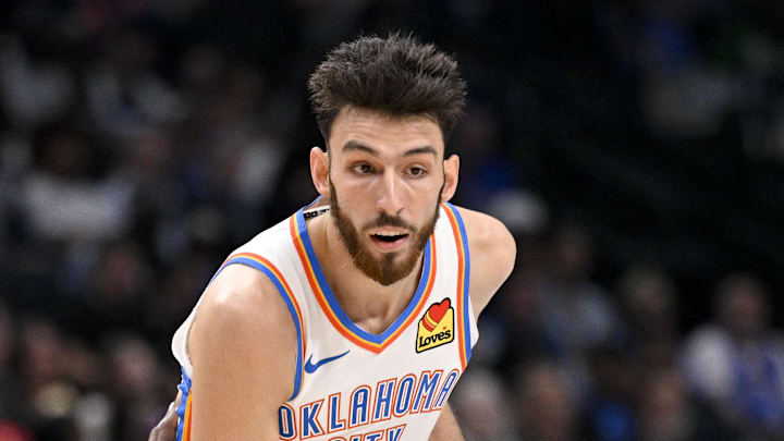 Oct 27, 2025; Dallas, Texas, USA; Oklahoma City Thunder center Chet Holmgren (7) looks to move the ball past Dallas Mavericks forward Naji Marshall (13) during the second quarter at the American Airlines Center. Mandatory Credit: Jerome Miron-Imagn Images