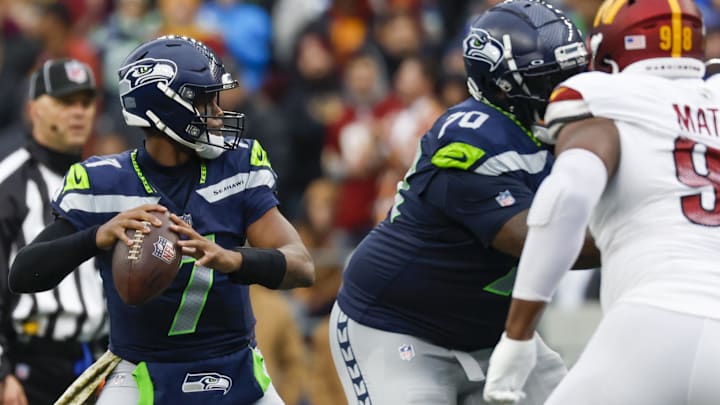 Nov 12, 2023; Seattle, Washington, USA; Seattle Seahawks quarterback Geno Smith (7) passes against the Washington Commanders with protection from Jason Peters during the second quarter at Lumen Field. Mandatory Credit: Joe Nicholson-Imagn Images