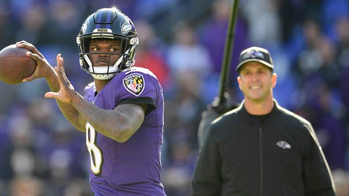 Baltimore Ravens quarterback Lamar Jackson passes as head coach John Harbaugh looks on Baltimore Ravens quarterback Lamar Jackson passes as head coach John Harbaugh looks on