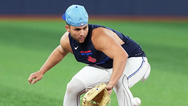 May 20, 2025; Toronto, Ontario, CAN; Toronto Blue Jays shortstop Bo Bichette (11) fields balls during batting practice before a game against the San Diego Padres at Rogers Centre. 