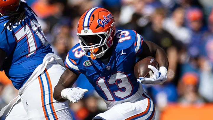 Nov 23, 2024; Gainesville, Florida, USA; Florida Gators running back Jadan Baugh (13) rushes with the ball against the Mississippi Rebels during the first half at Ben Hill Griffin Stadium. Mandatory Credit: Matt Pendleton-Imagn Images