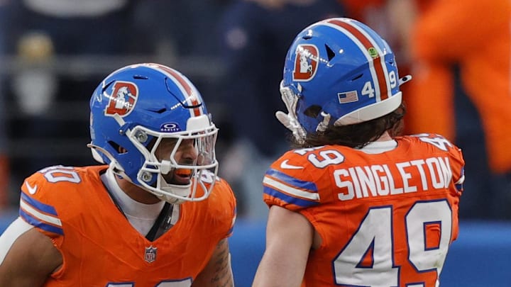 Jan 4, 2026; Denver, Colorado, USA; Denver Broncos linebacker Justin Strnad (40) celebrates with linebacker Alex Singleton (49) after a sack during the second half against the Los Angeles Chargers at Empower Field at Mile High. Mandatory Credit: Isaiah J. Downing-Imagn Images