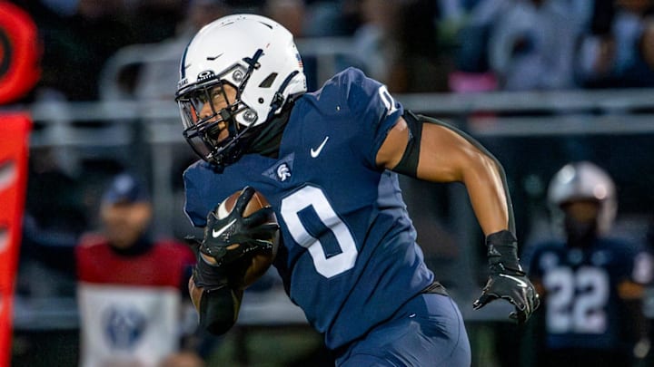 East Lansing's Jace Clarizio runs for a gain against DeWitt during the second quarter on Friday, Sept. 27, 2024, at East Lansing High School.